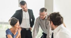 Group of men and women business professionals meeting