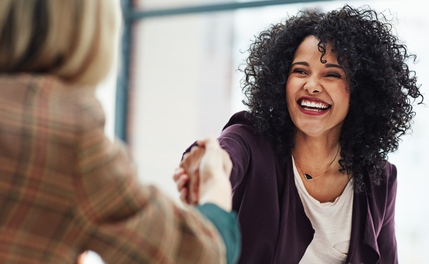 Leader laughing with coworker
