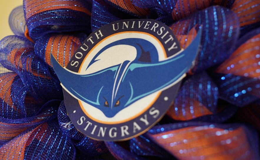 stingray logo on an orange and blue wreath